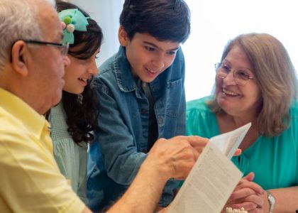 Happy family moments with grandparents and grandchildren enjoying time together indoors.